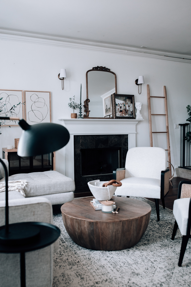 round wood coffee table in modern neutral living room. 