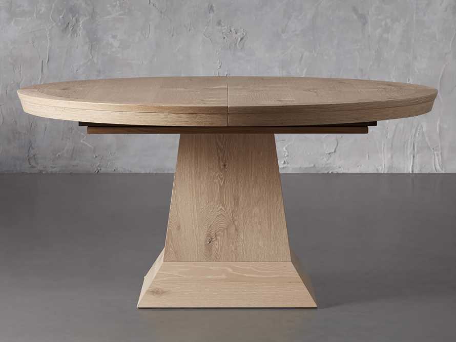 extendable round dining table with a pedestal base. 