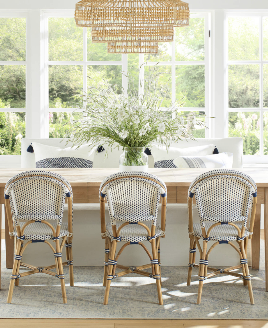 serena and lily extendable dining table in oak with rattan chairs. 