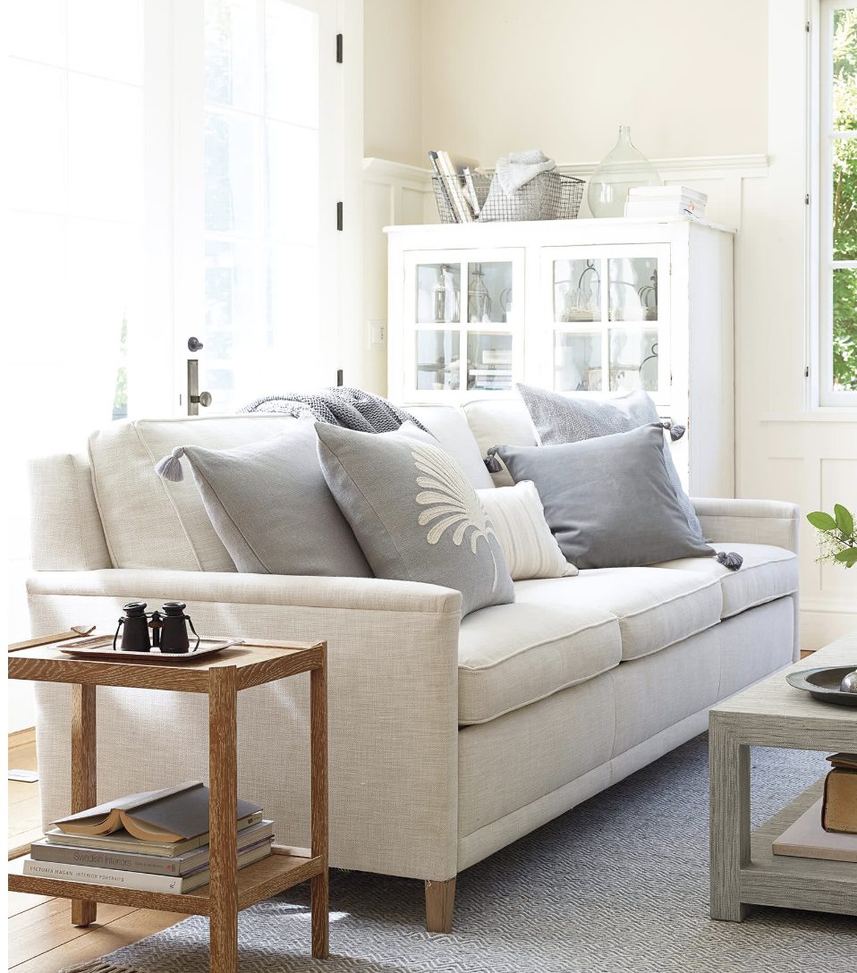 white pull-out sleeper sofa in living room. 