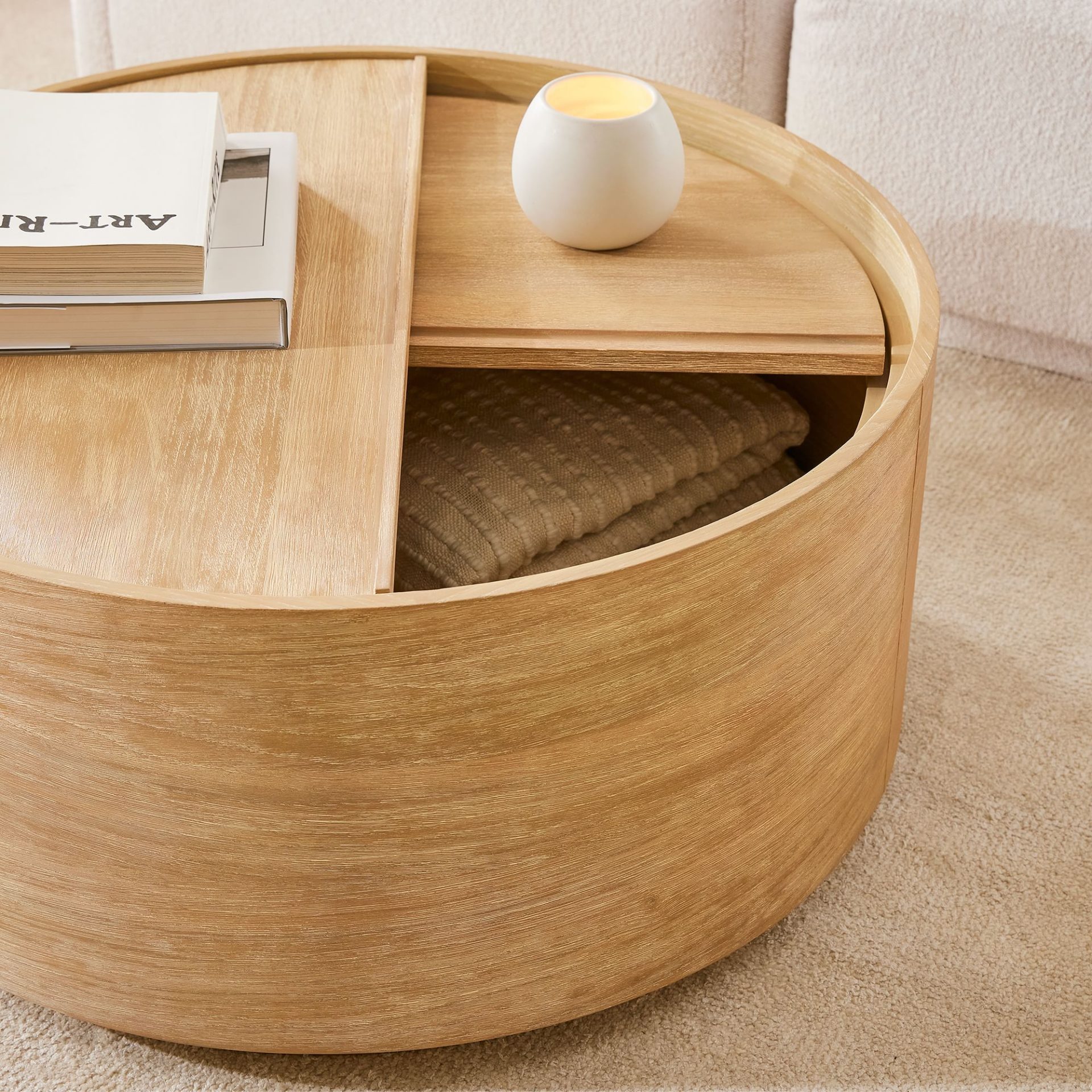 hidden storage compartment round coffee table with coffee table books. 