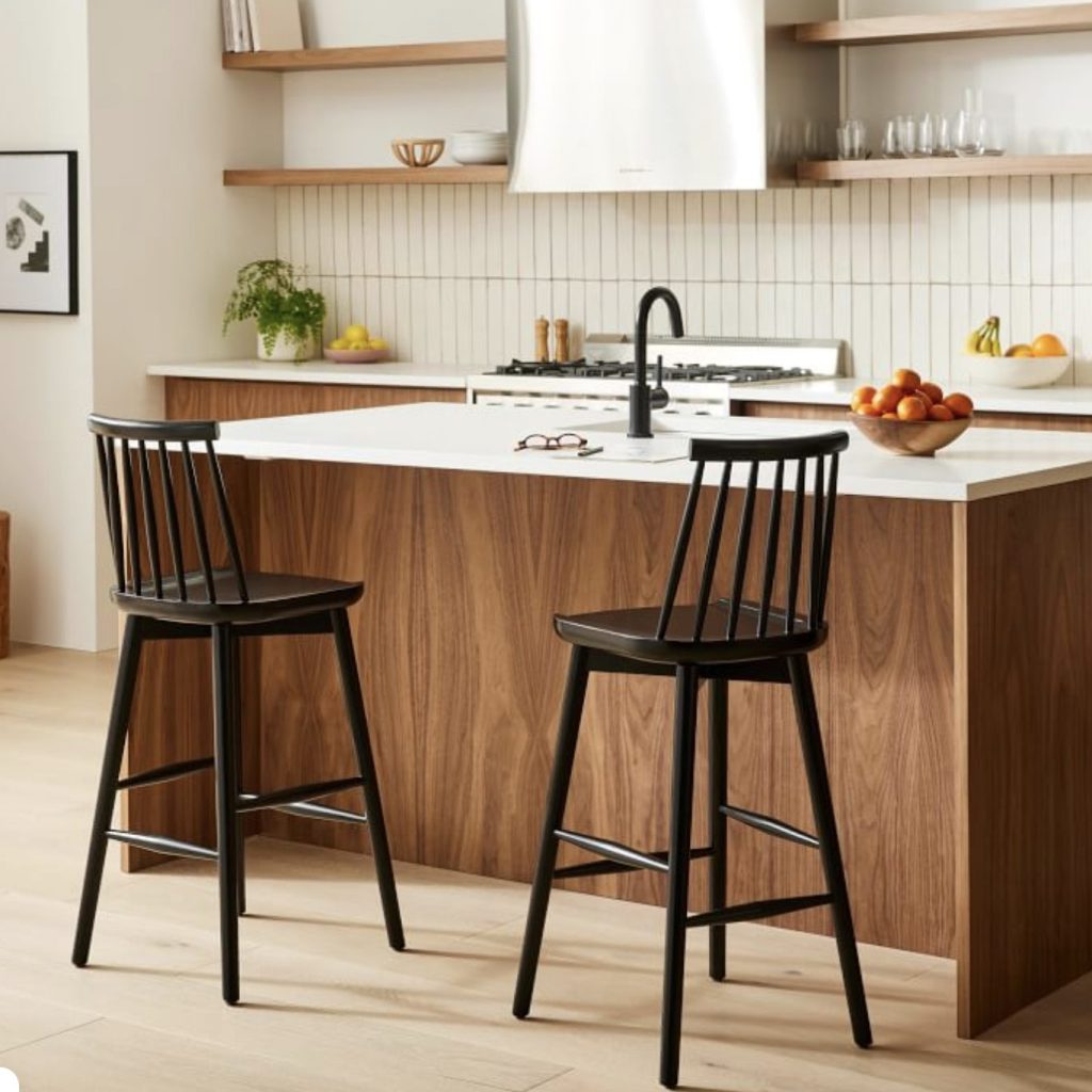 black wooden bar stools with backs at kitchen counter.