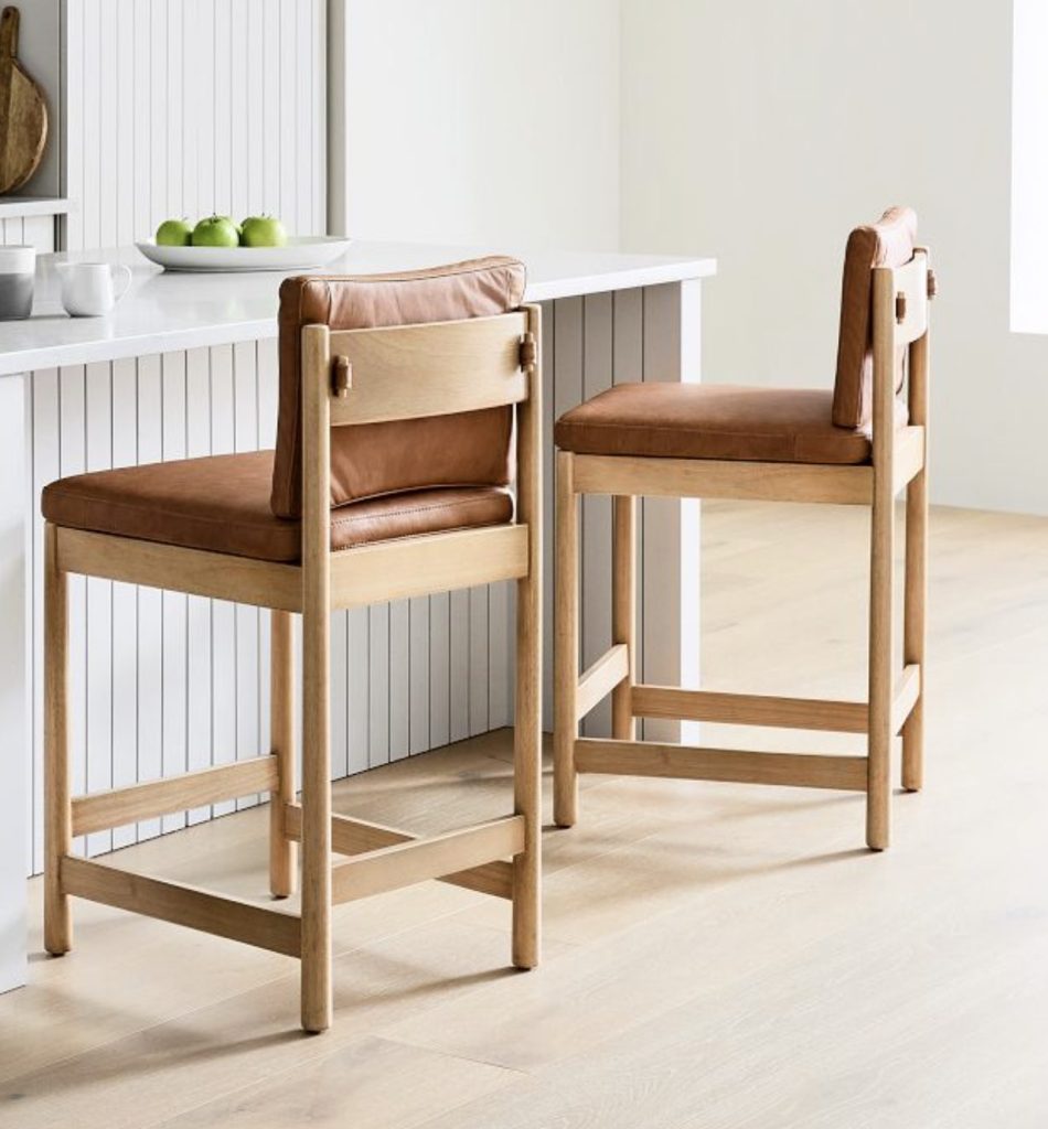 brown leather and wood bar stools with backs.