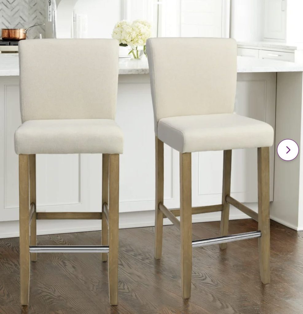 white fabric and wooden bar stools. 