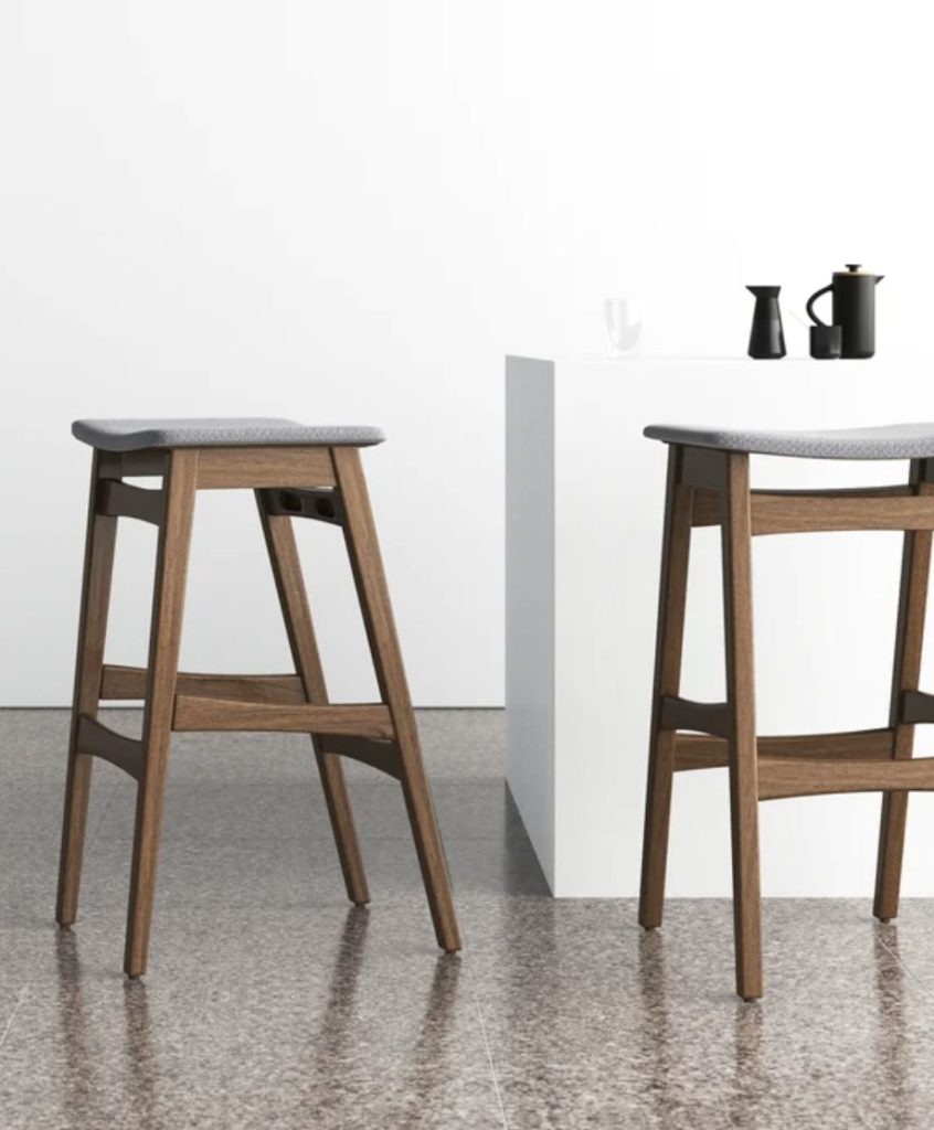 backless bar stool in dark wood and fabric.