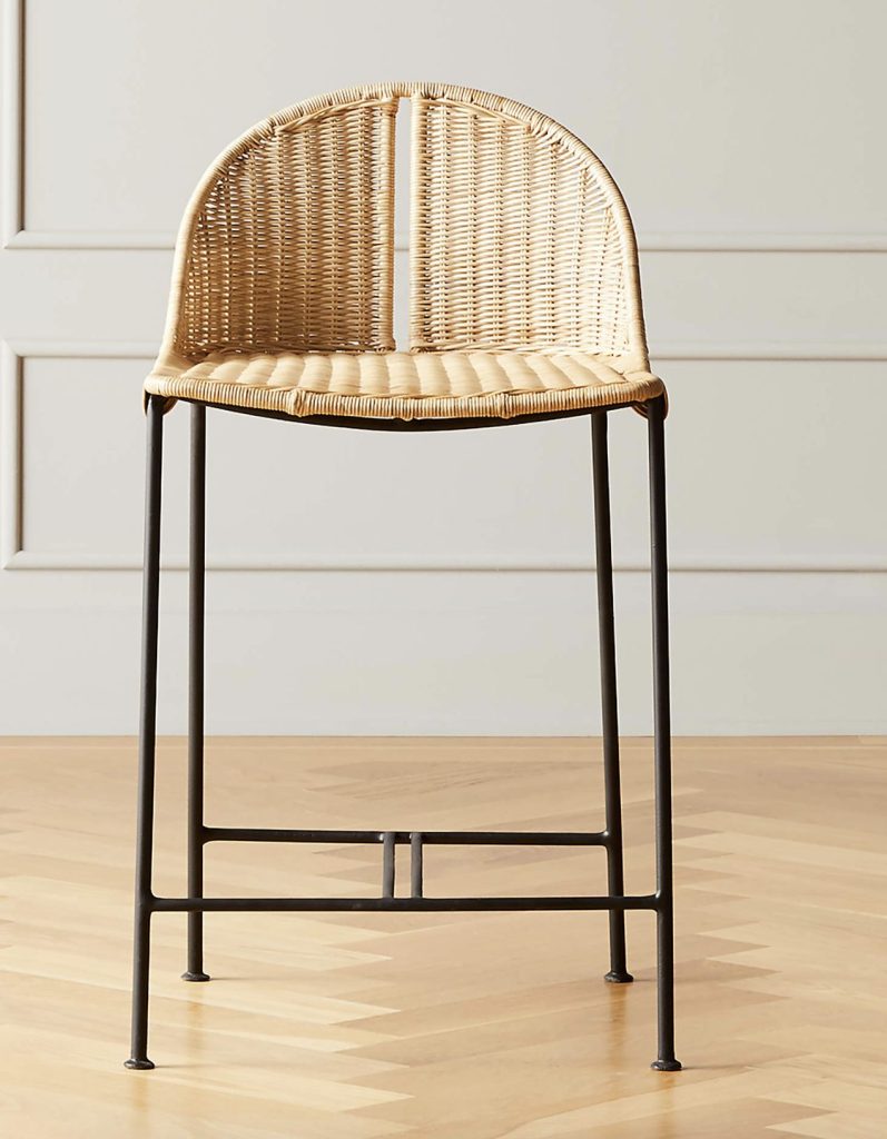 a rattan counter stool with black metal legs. 