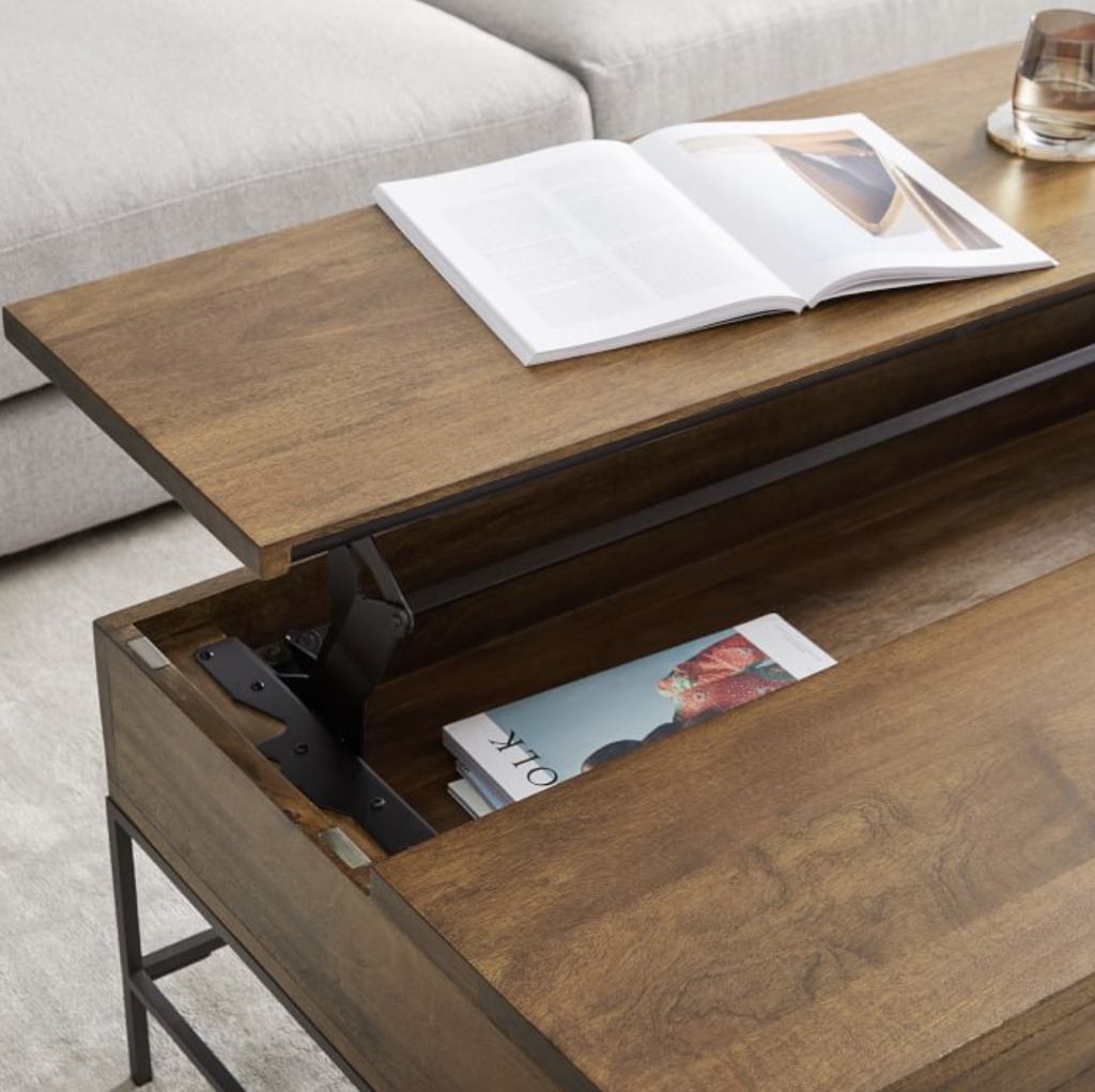 rustic pop-up top storage coffee table with books and magazines. 