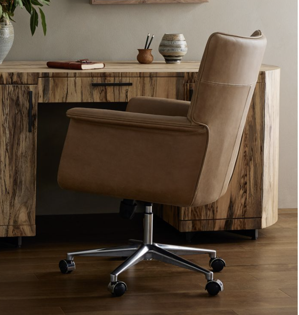 brown leather swivel desk chair at a wooden desk. 