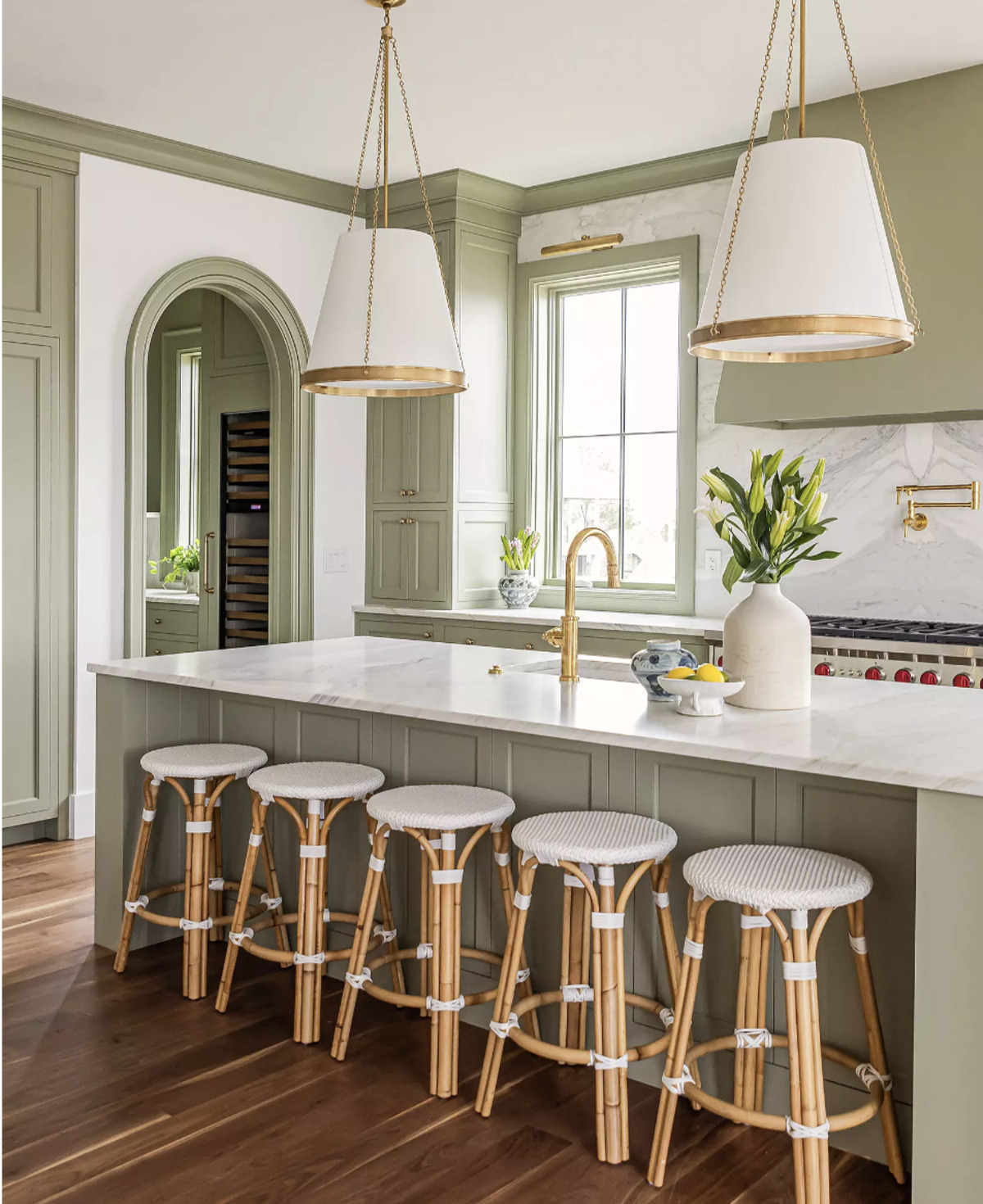 5 backless bistro rattan bar stools at a kitchen island. 