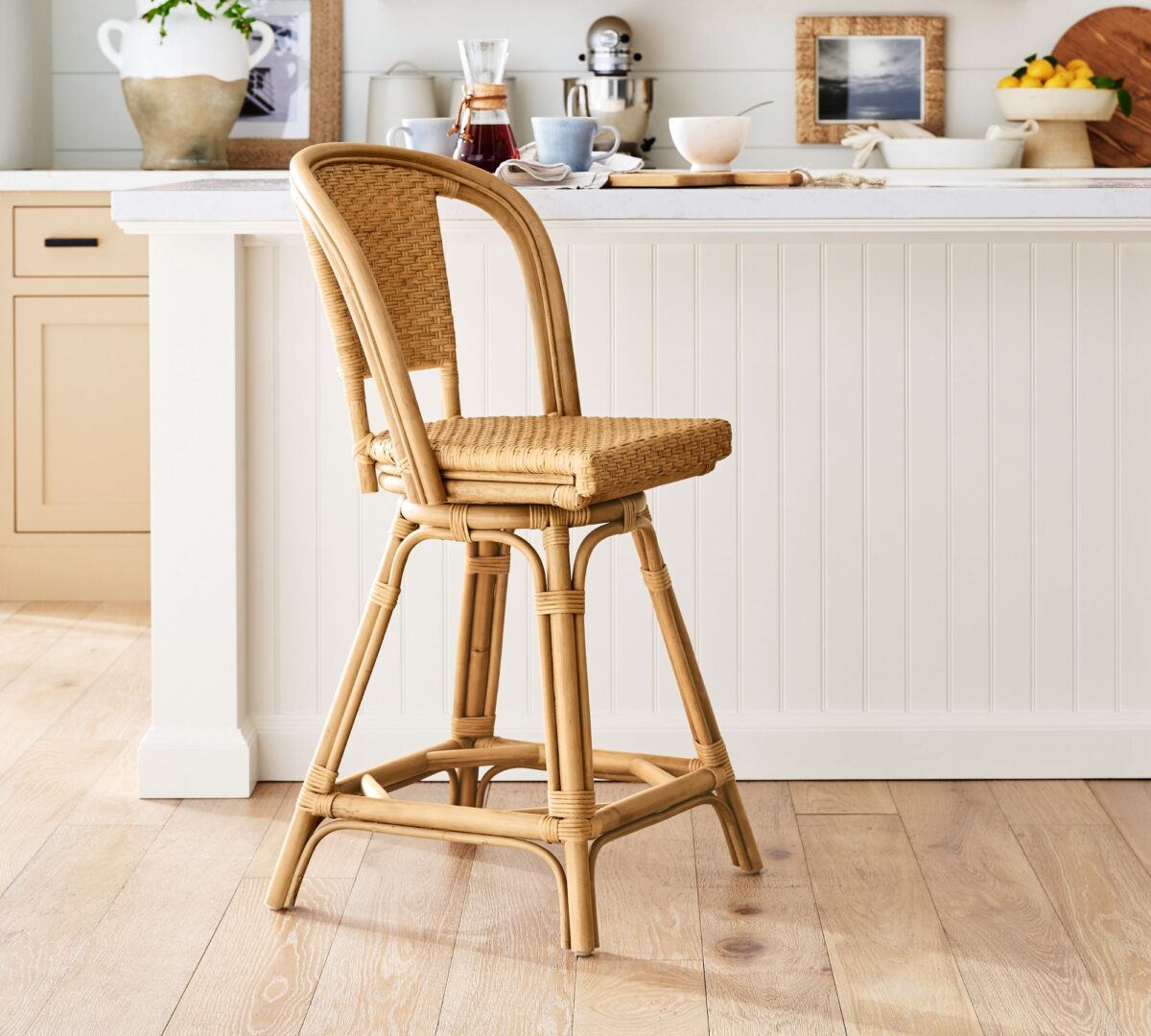 cafe bistro rattan swivel counter stool at a white kitchen island.