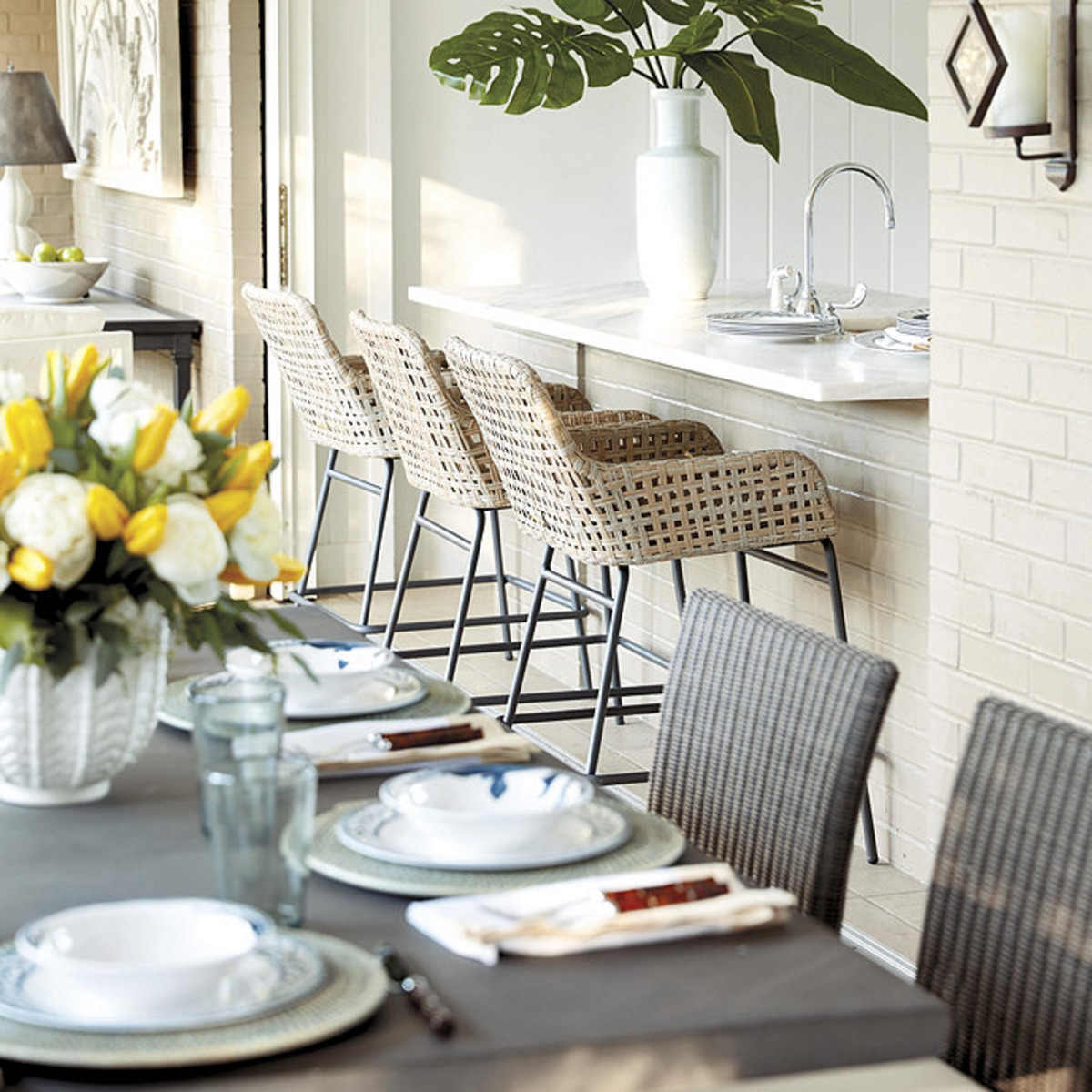 woven counter stools with decorative plates at a kitchen island. 